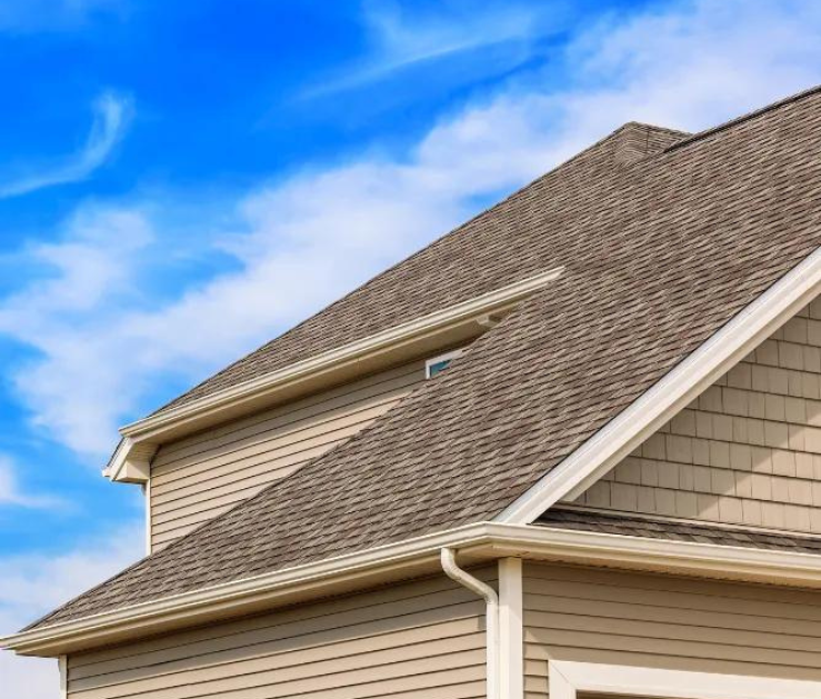 The roof of a house with a blue sky in the background