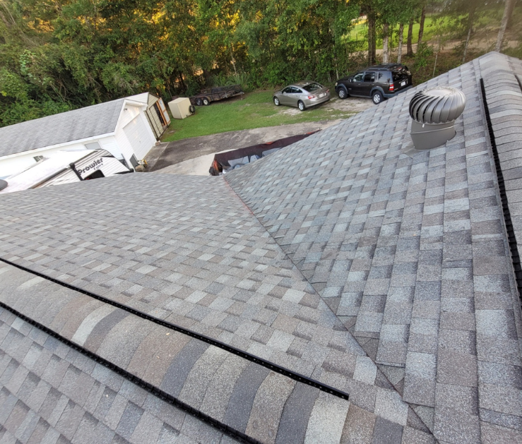 An aerial view of a roof with a wind turbine on it.