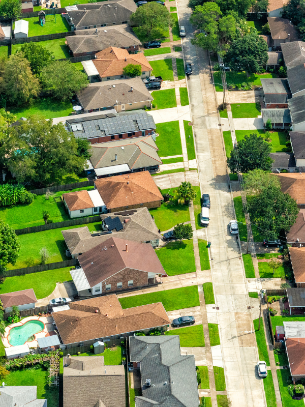 An aerial view of a residential neighborhood with lots of houses and trees.