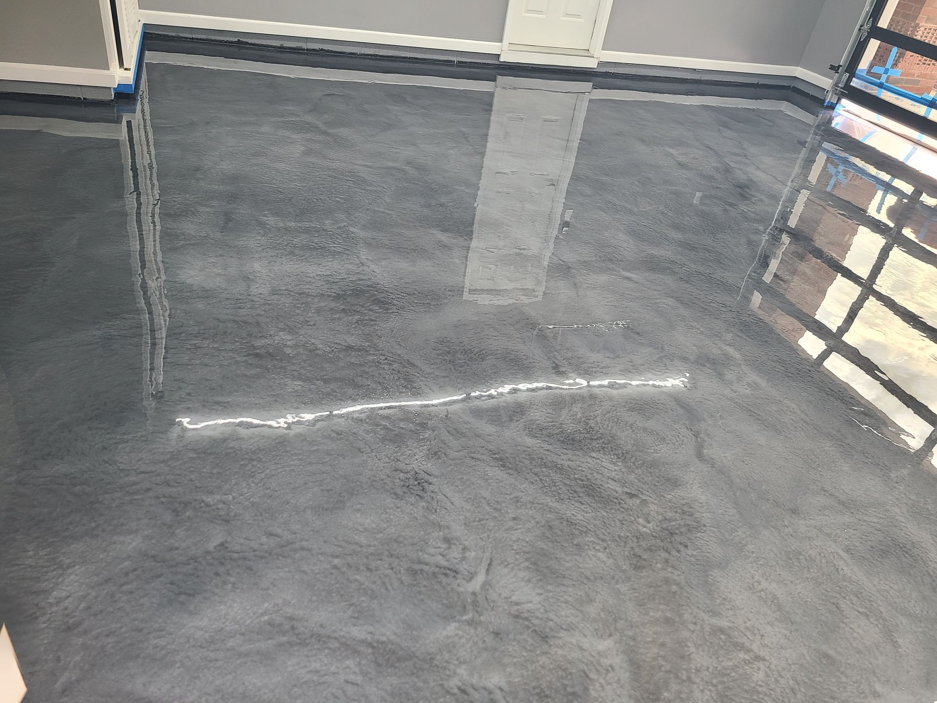 A large room with a shiny metallic floor and wooden walls.