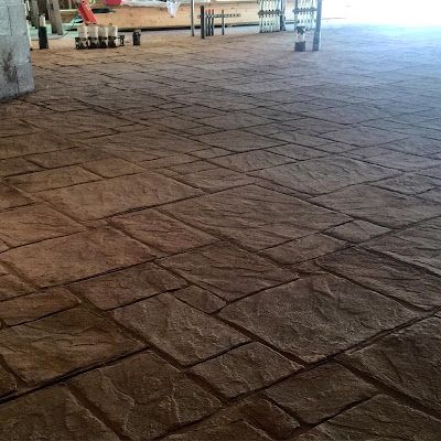 A close up of a brick floor with candles on it.