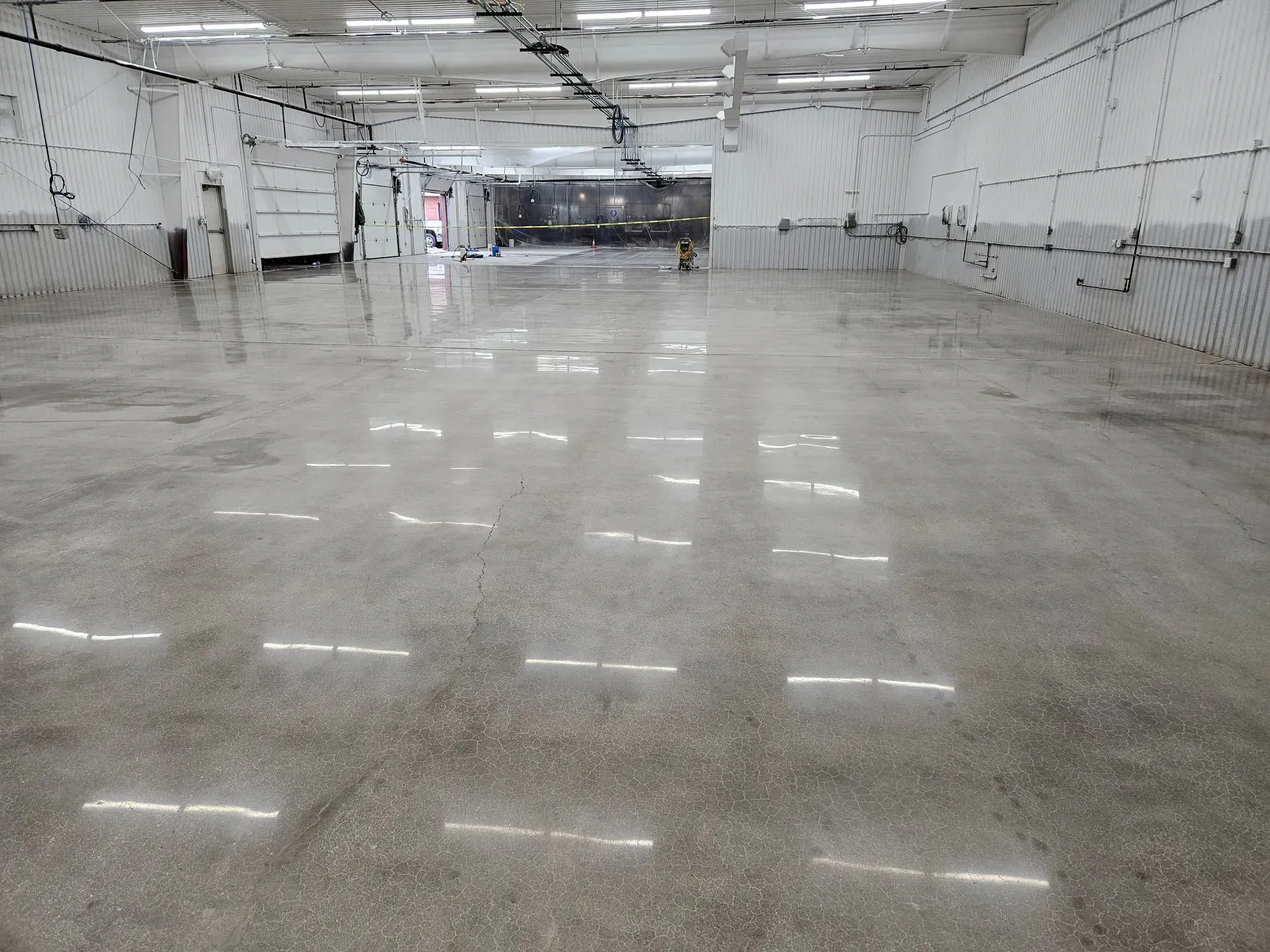 A large empty warehouse with a shiny concrete floor