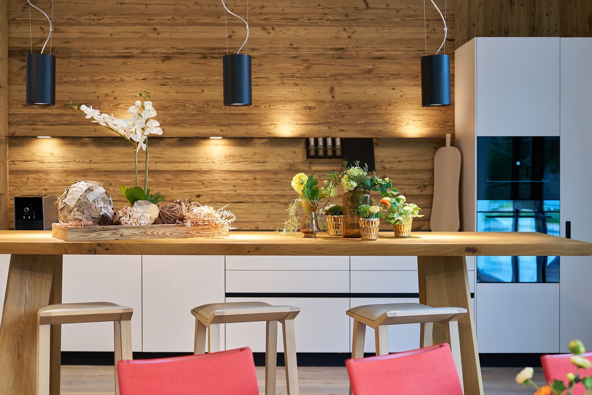 Eine Küche mit langem Holztisch und Hockern