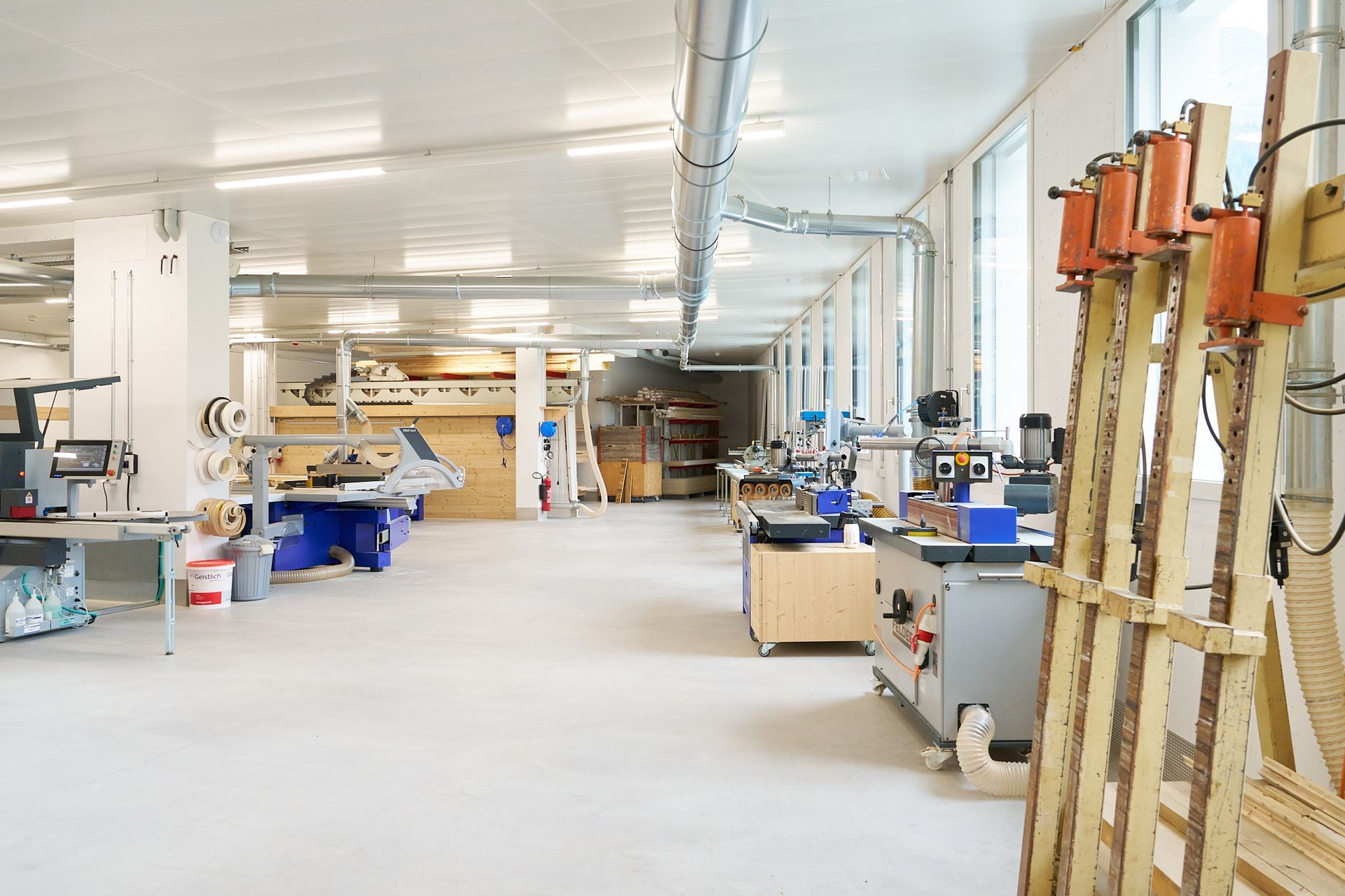 Ein großer Raum mit vielen Maschinen in einer Fabrik.