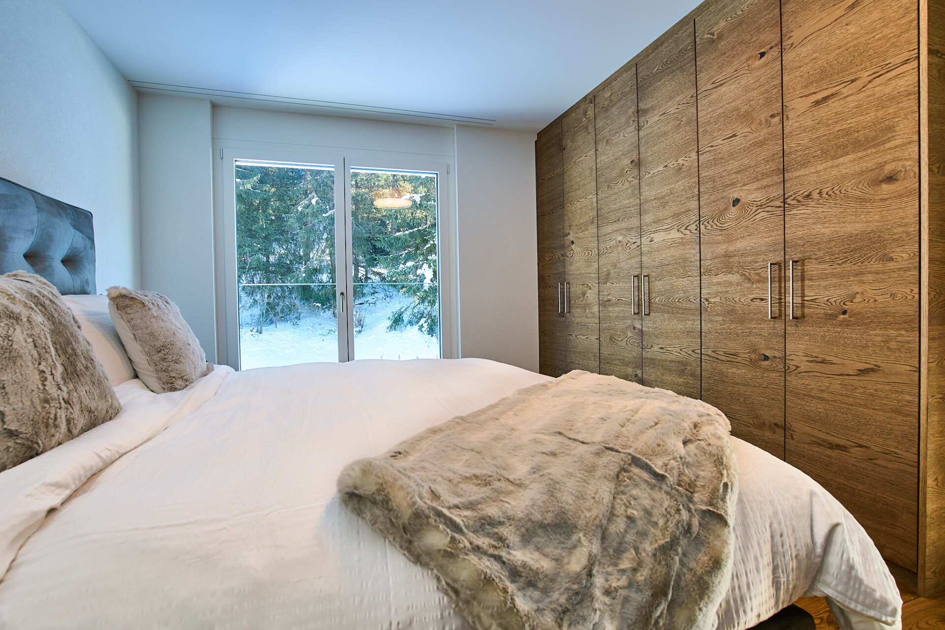 Ein Schlafzimmer mit Kingsize-Bett und großem Fenster.