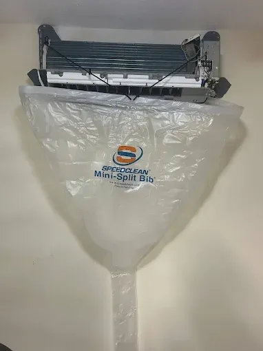 Wall-mounted electric insect zapper inside a clear plastic cover bag