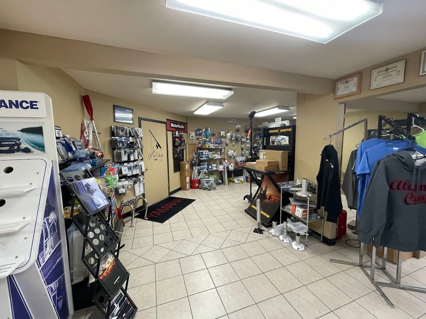 A large room with a lot of clothes hanging on racks.