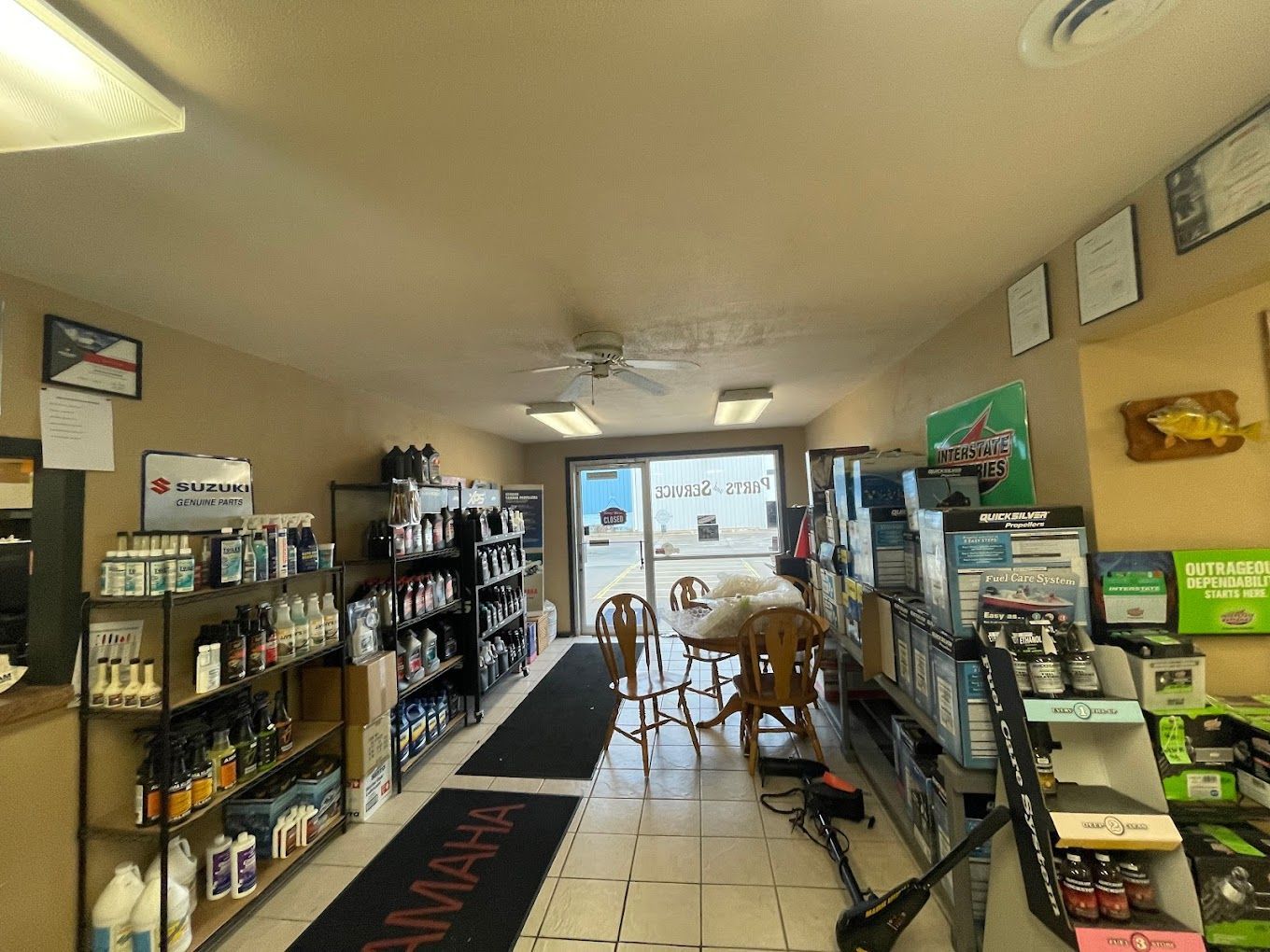 A store filled with lots of products and a table and chairs.