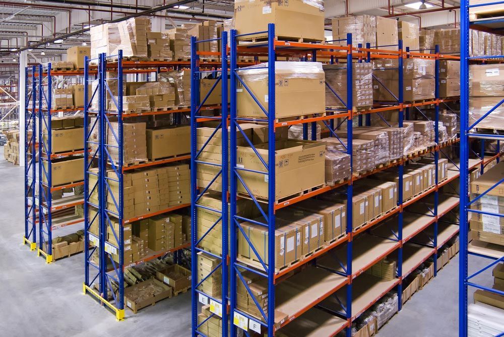 A Warehouse Filled With Lots of Boxes and Shelves — Ocean Grove Removals In Whittington, VIC