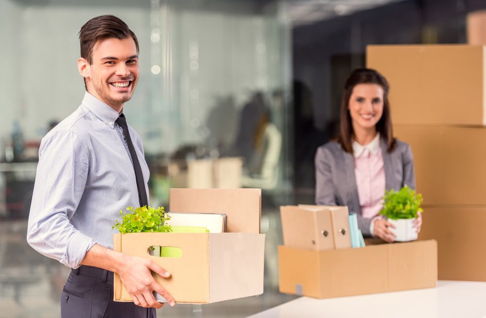 A Man and a Woman Are Moving Into a New Office — Ocean Grove Removals In Ballarat, VIC
