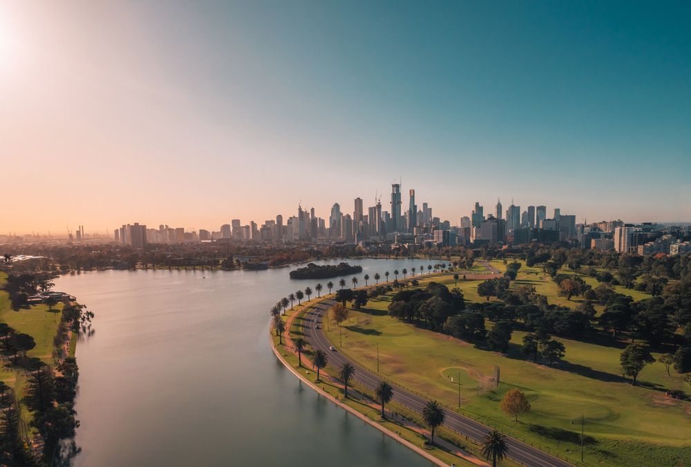 An Aerial View of a Lake With a City Skyline in the Background — Ocean Grove Removals In Melbourne, VIC