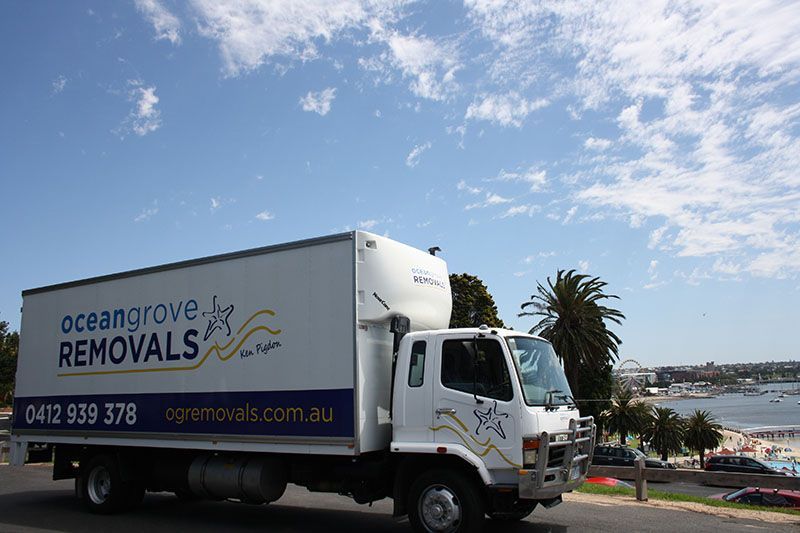 A White Ocean Grove Removals Truck is Parked on the Side of the Road — Ocean Grove Removals In Whittington, VIC 