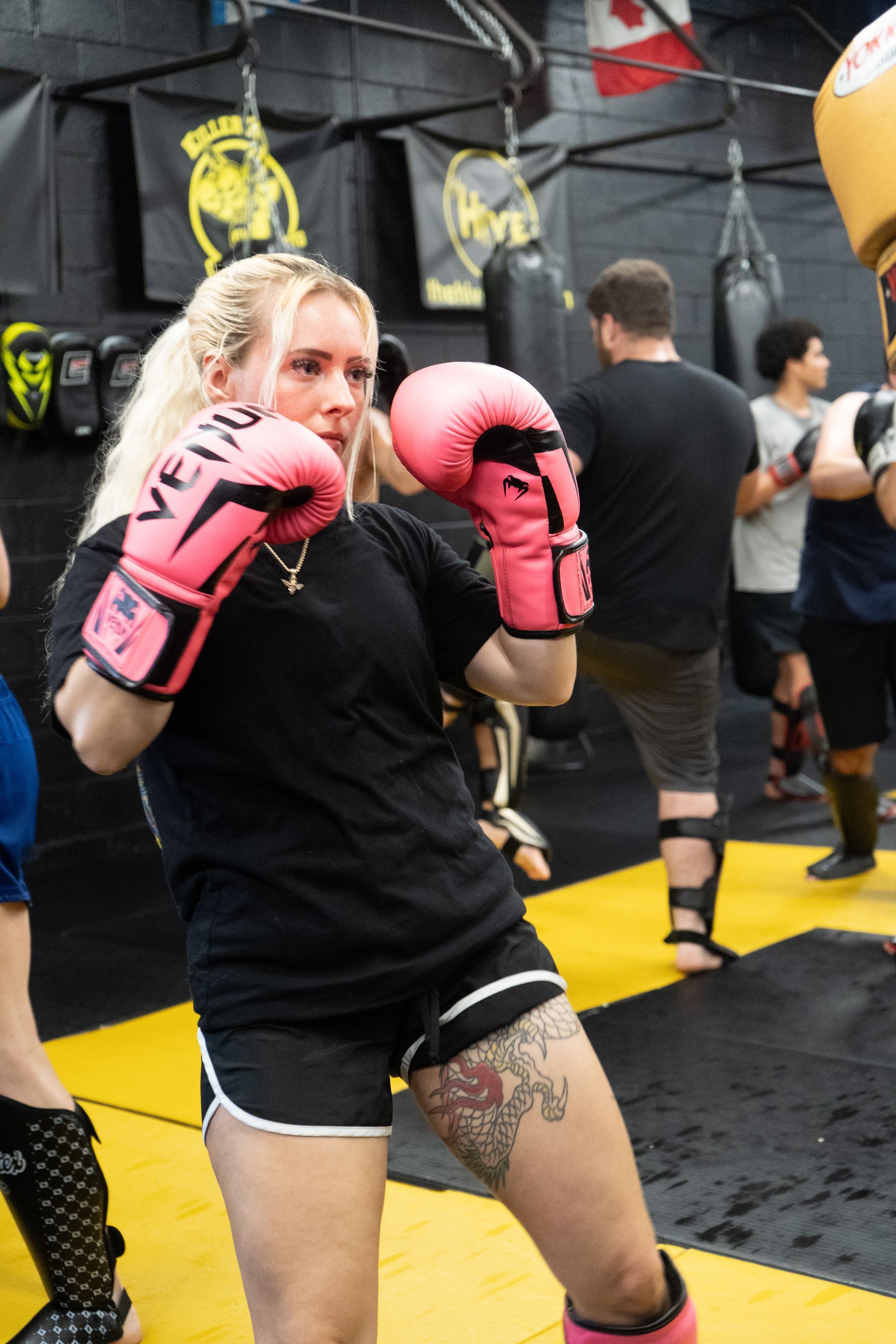 Adults training striking and grappling at Killer B Combat Academy in Oakhurst, NJ, building calm focus and resilience.
