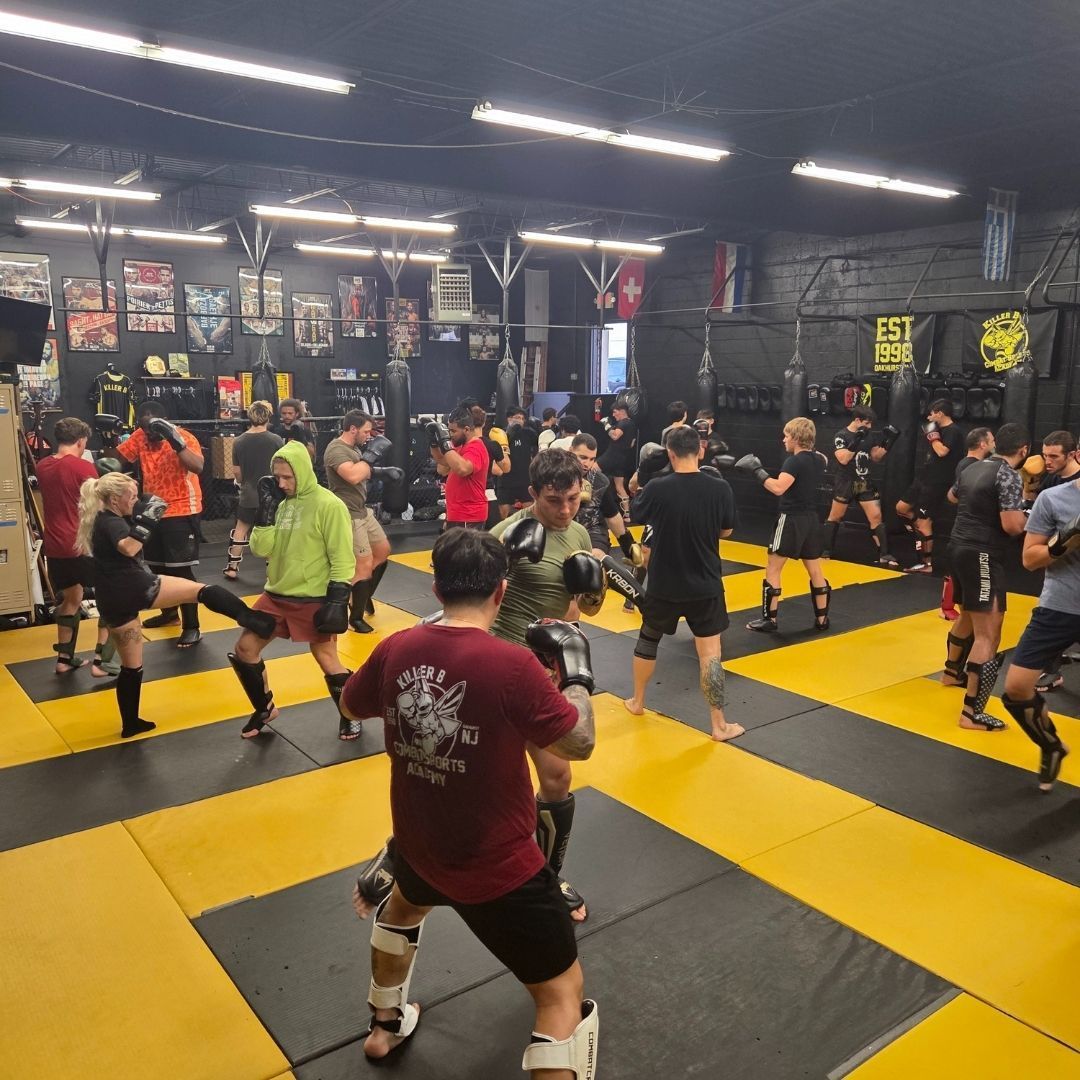 Adults practicing kickboxing combinations at Killer B Combat Academy in Oakhurst, NJ for fitness and confidence.