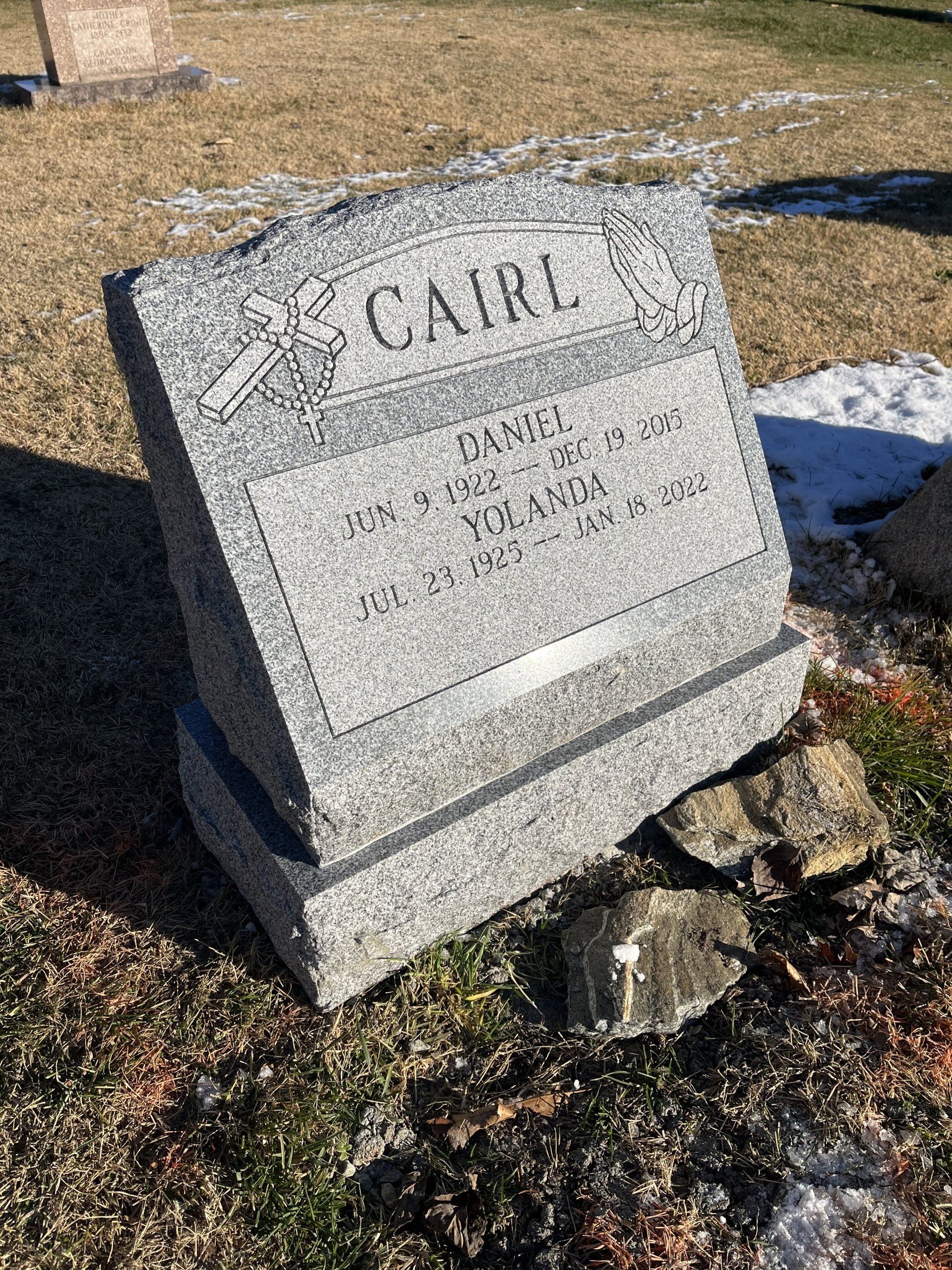 Cairl flat carved designs serp top barre grey base deep carved lettering double outlined panel multiple names cross praying hands rosary beads brp sides