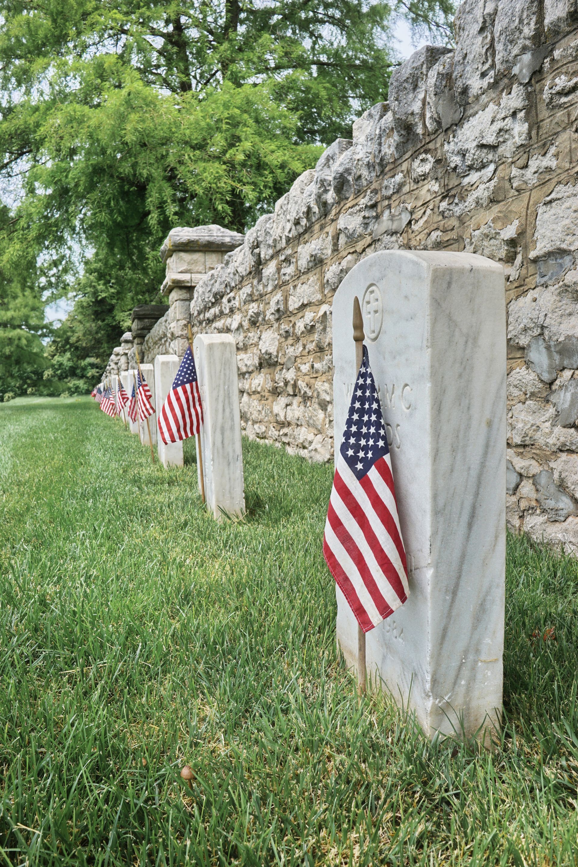 A photo showing a row of veterans' memorial headstones