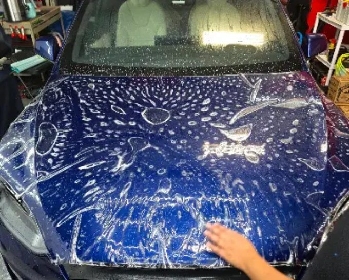 Blue hood fitted with paint protection film at CM3 Detailing Studio & Ceramic Coating in Elgin, IL
