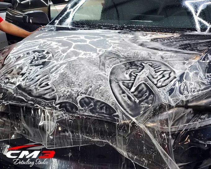 Dark vehicle getting paint protection film at CM3 Detailing Studio & Ceramic Coating in Elgin, IL