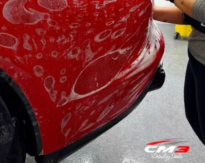 Red vehicle getting paint protection film at CM3 Detailing Studio & Ceramic Coating in Elgin, IL