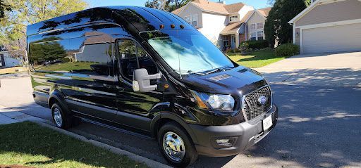 Black Ford Transit van with full window tint on all windows parked outdoors