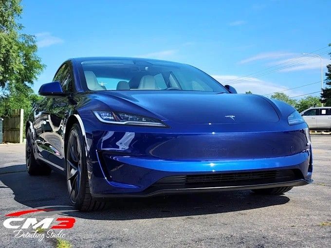 Blue Tesla Model 3 parked outdoors showing a deep gloss finish after ceramic coating