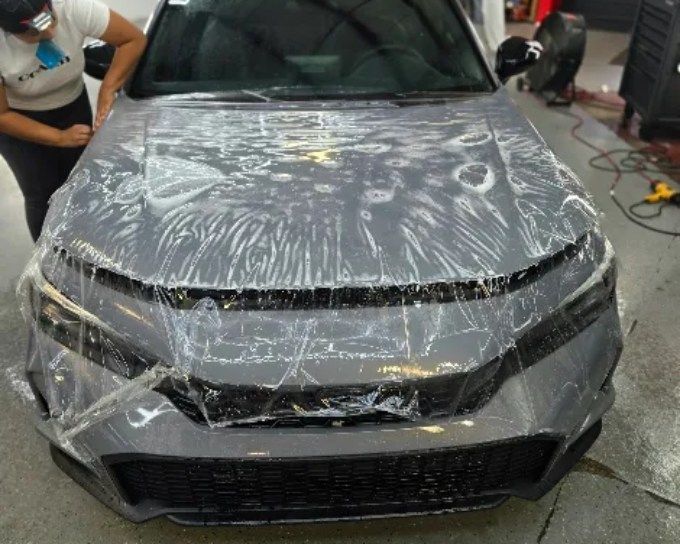 Dark car during paint protection film installation at CM3 Detailing Studio & Ceramic Coating in Elgi