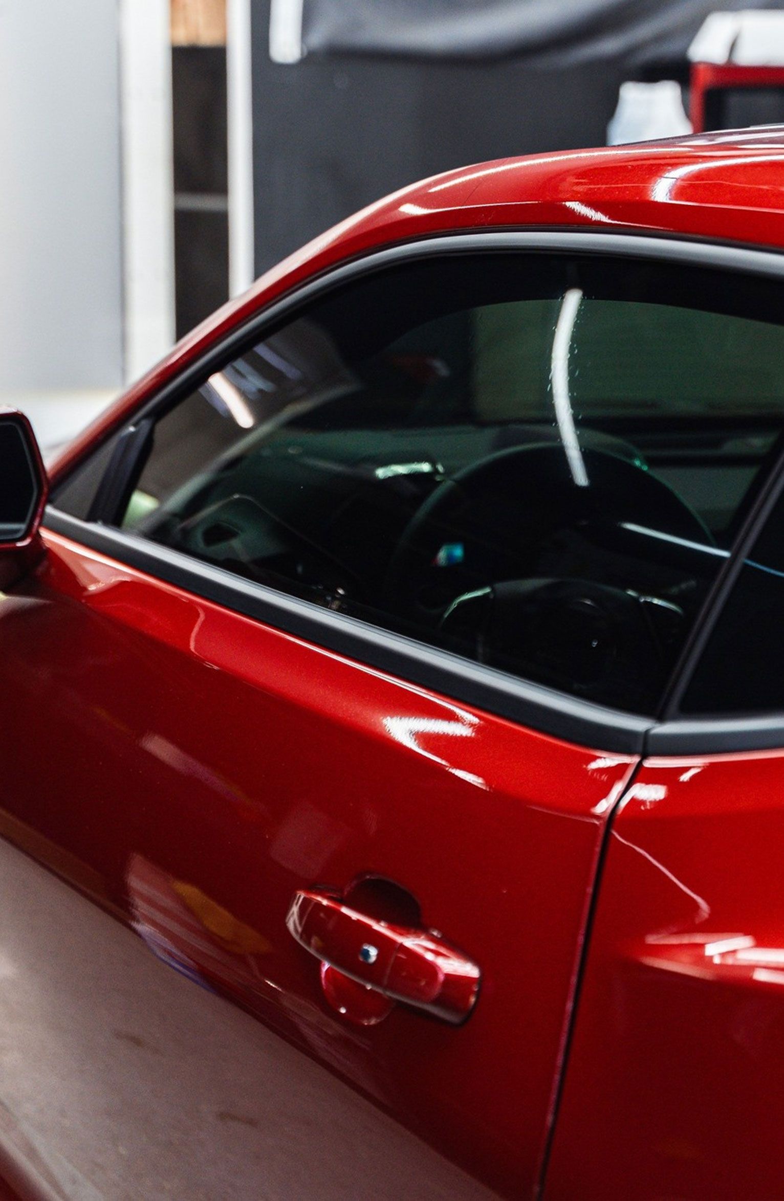 Red car with clean window tint installed