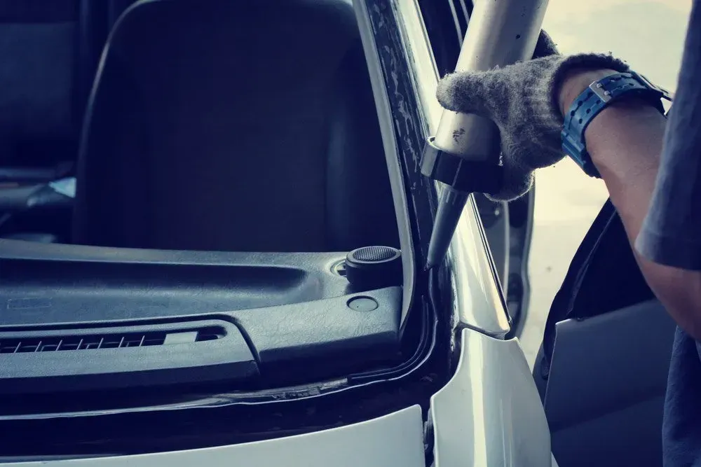 Person Applying Sealant Around a Car Windshield Frame — Hervey Bay Mobile Windscreens in Pialba, QLD