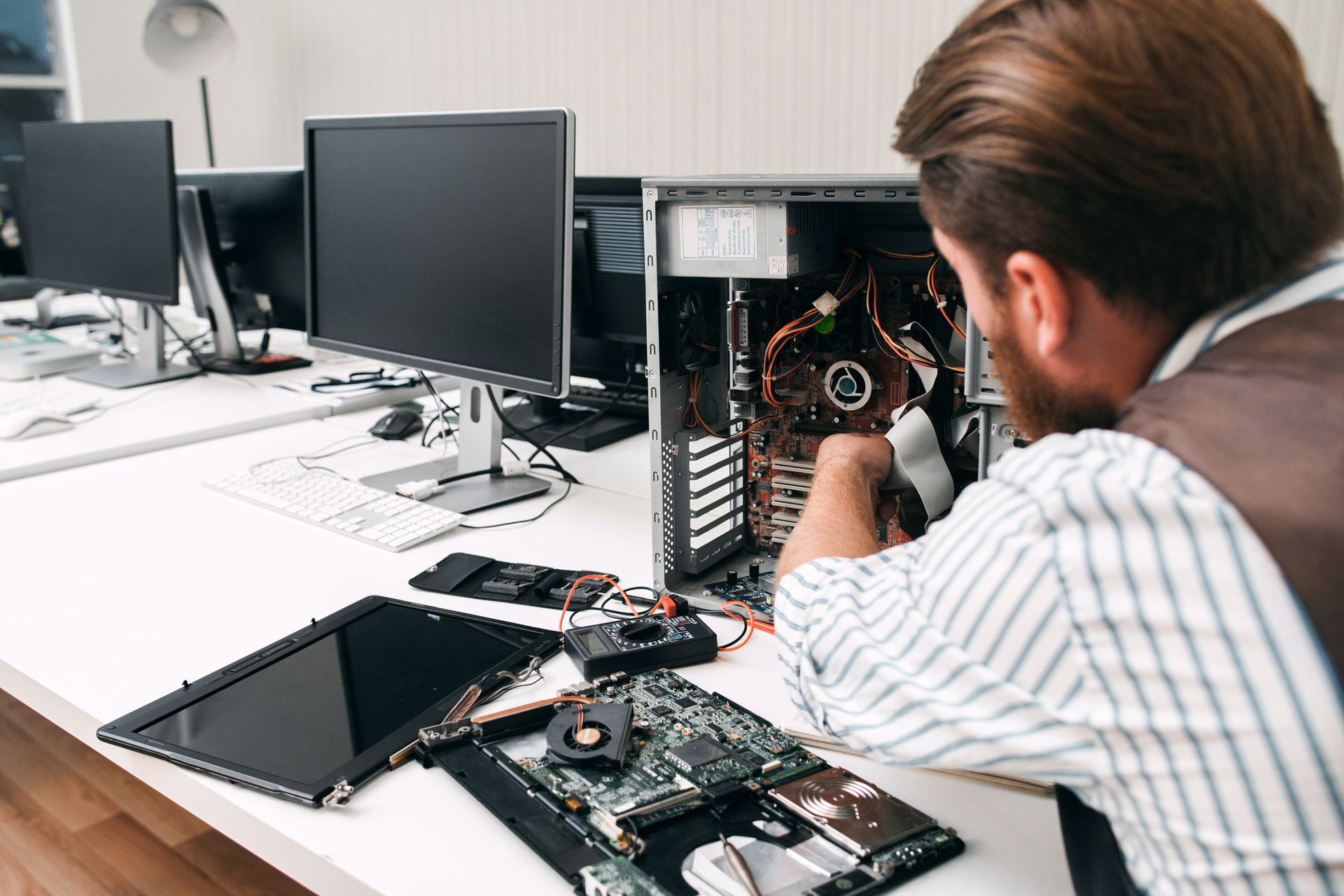 A man is working on a computer in an office.