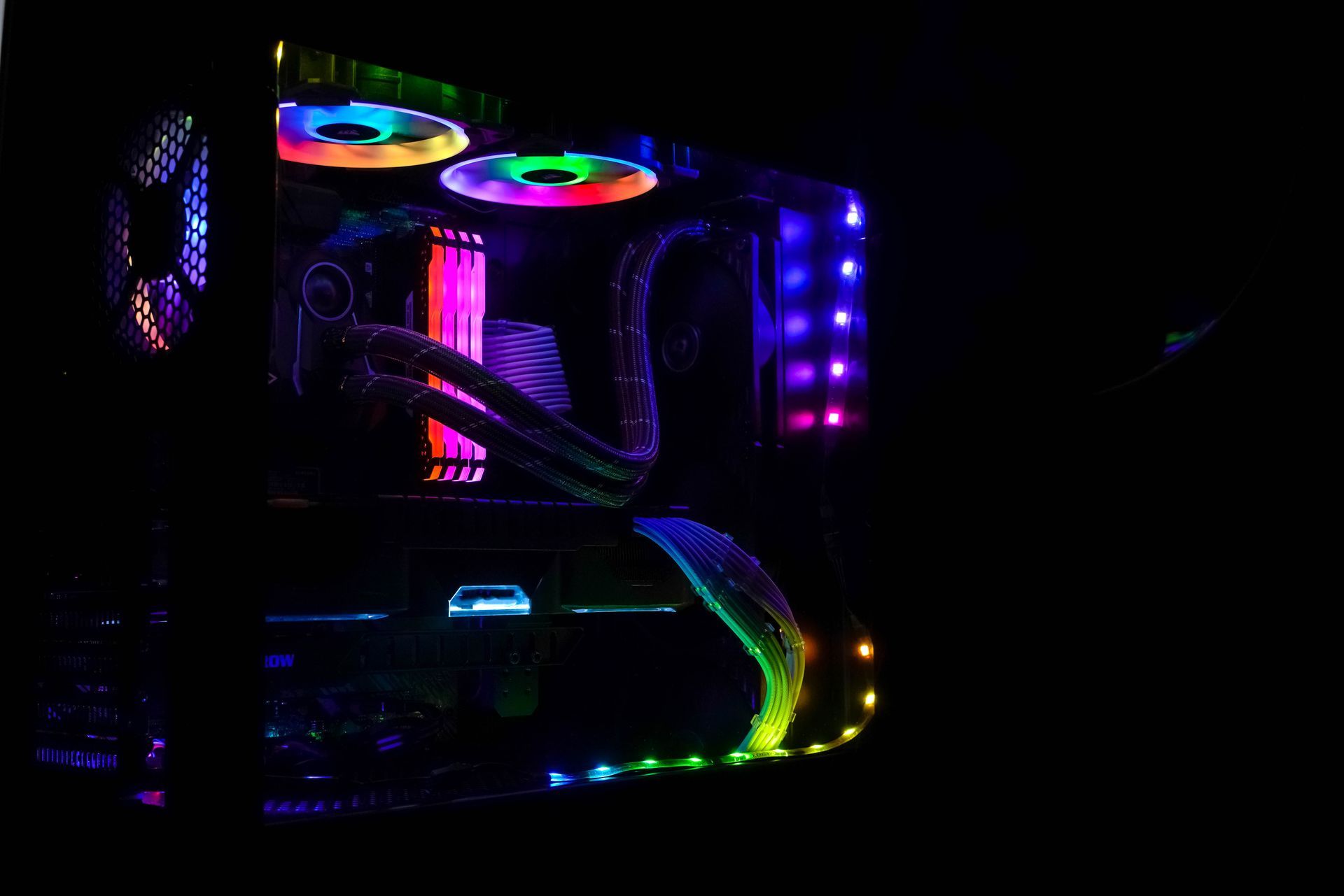 A computer case with a lot of lights on it in the dark.