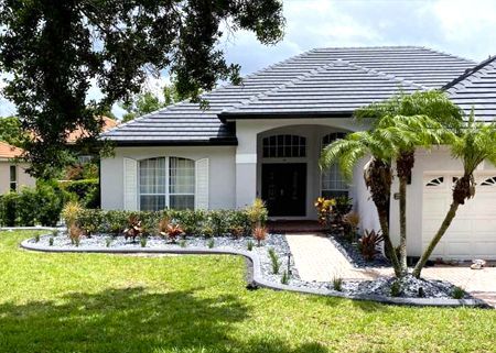 A white house with a palm tree in front of it