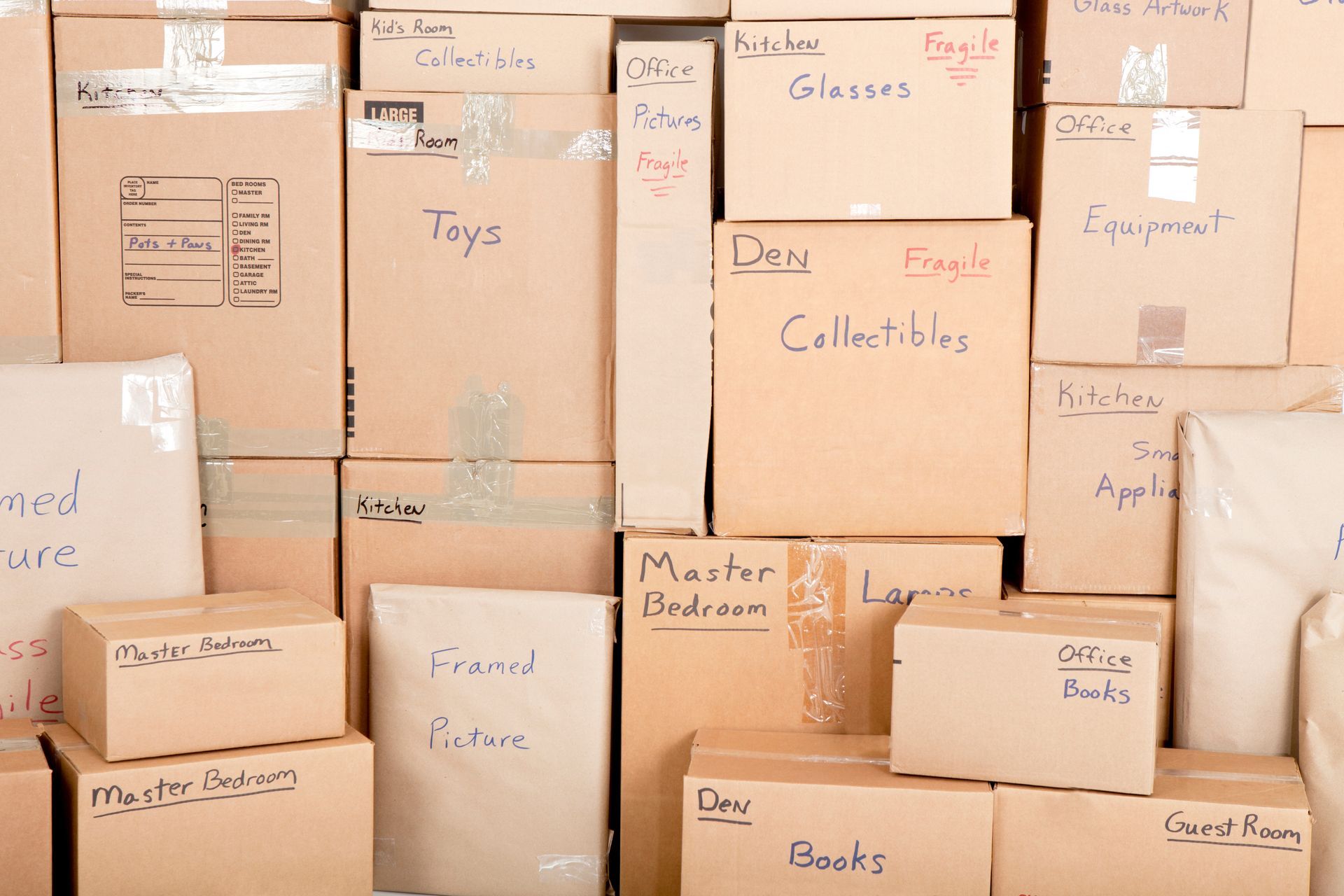 A pile of cardboard boxes with one labeled toys