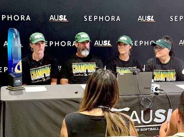Four championship-clad speakers at a SEPHORA sponsor press table during a panel discussion
