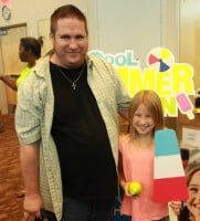 Man and girl pose by a