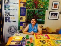 Woman at a booth promoting