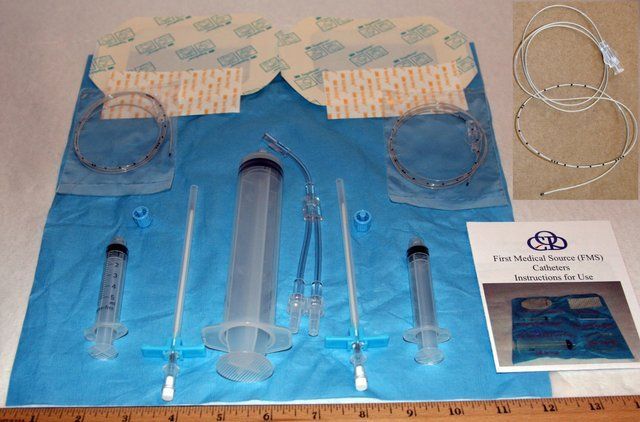 Contents of the FMS double-site anesthesia kit laid out: catheters, introducer needles, syringes, dressings and instructions