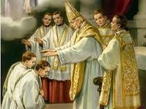 Bishop blessing kneeling man while altar servers stand nearby in a church setting