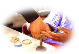 Hands exchanging rings over a table during a ceremony