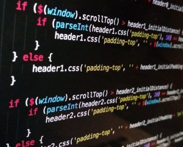 Close-up of code on a computer screen with colorful syntax highlighting on a dark background
