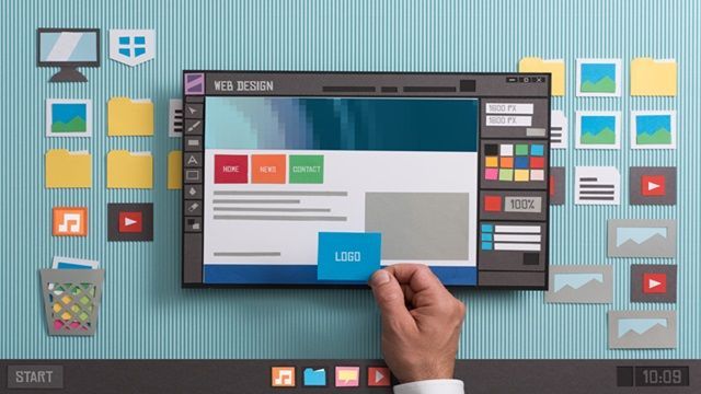 Hand placing a blue button on a website mockup with colorful app icons around a screen