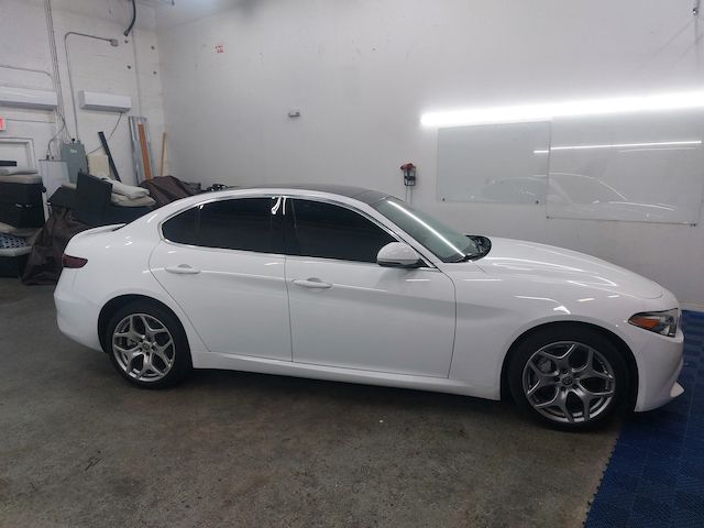 A white car is parked in a garage.