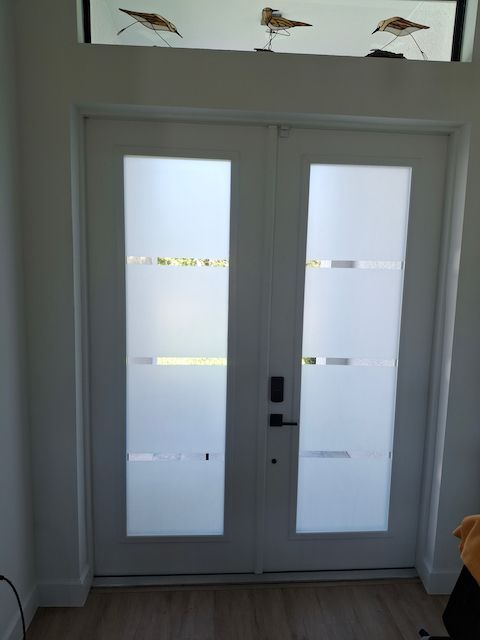 A pair of white doors with birds on them