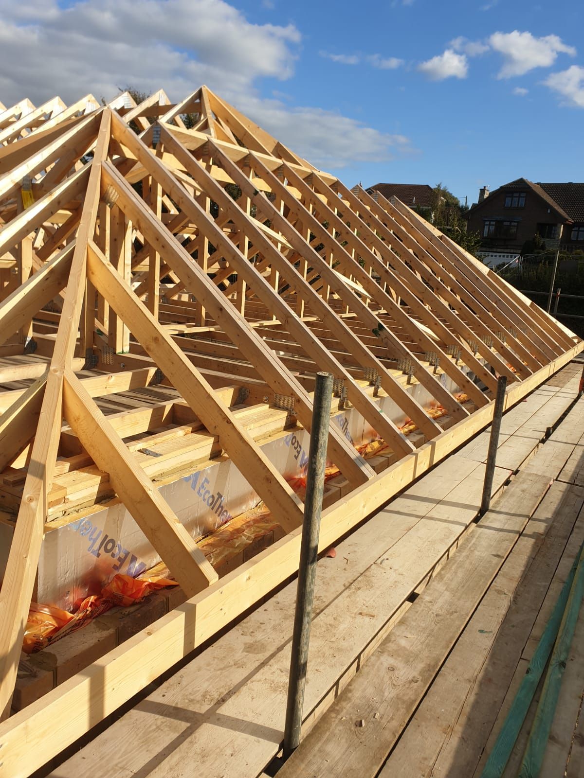 A wooden roof is being built on a scaffolding.