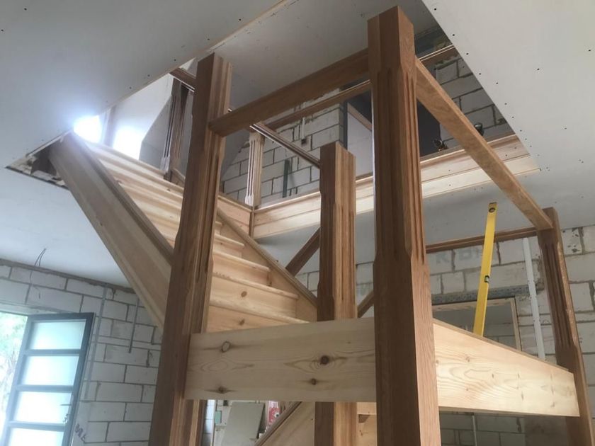 A wooden staircase is being built in a building.