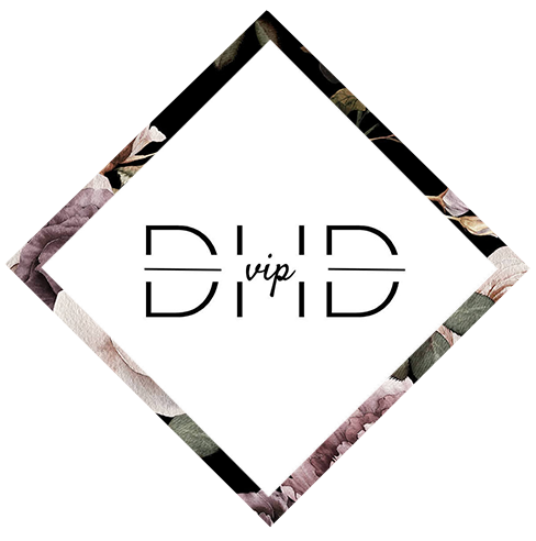 Black diamond with floral design framing the letters