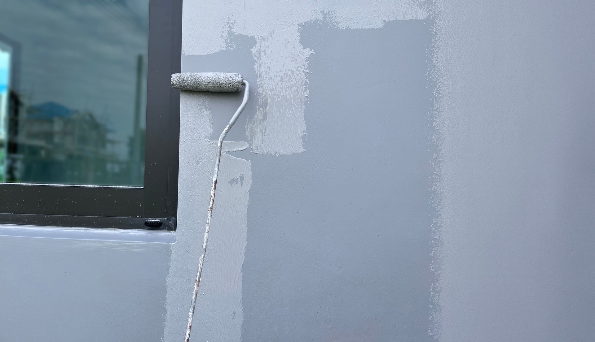 A gutter on the side of a house with a blue sky in the background