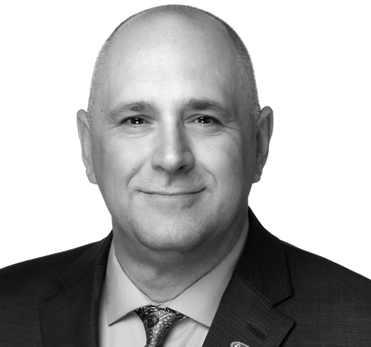 A man wearing a suit and tie has a pin on his jacket that says florida