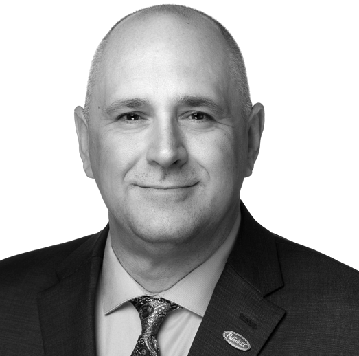 A man wearing a suit and tie has a pin on his jacket that says florida