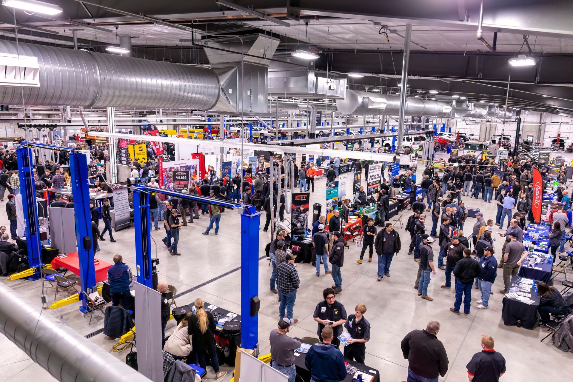 A large group of people are standing in a large room.