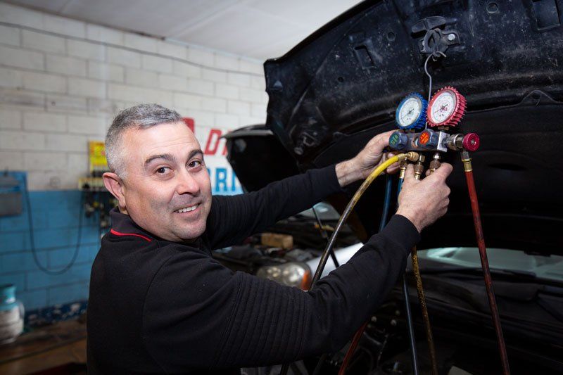A Man Checking The Condition Of A Car - Adelaide, SA - Silver’s Auto Centre A Man Checking The Condition Of A Car - Adelaide, SA - Silver’s Auto Centre